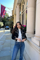 a lady wears a black tweed jacket with skinny jeans